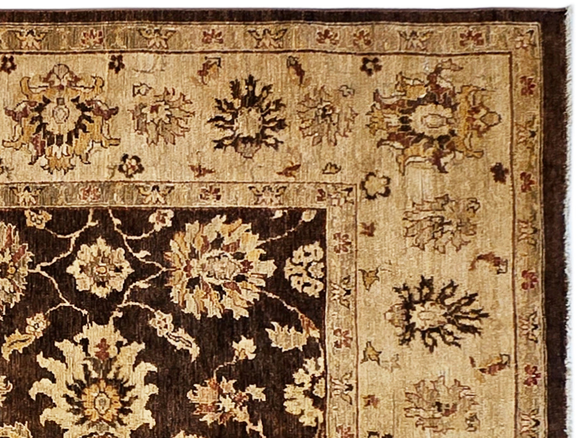 Close-up of rug texture with cream and dark brown floral motifs; detailed ornate border