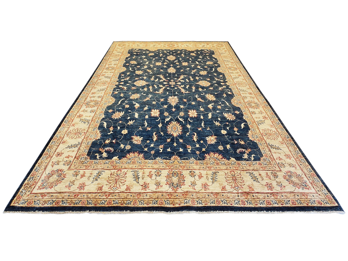 Large rectangular navy rug with cream patterned border and red floral corner accents.