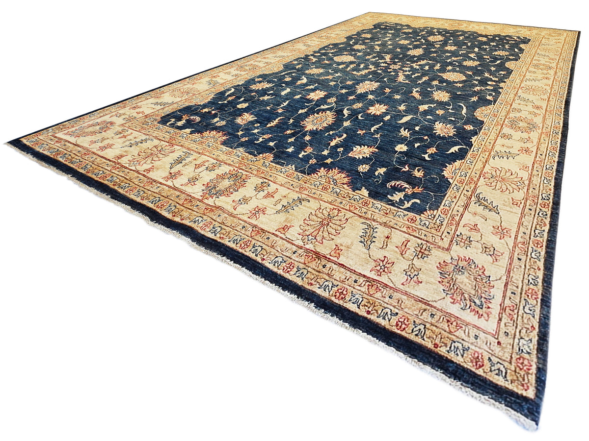 Traditional navy blue rug with cream and red floral border, decorative medallions, fringe.