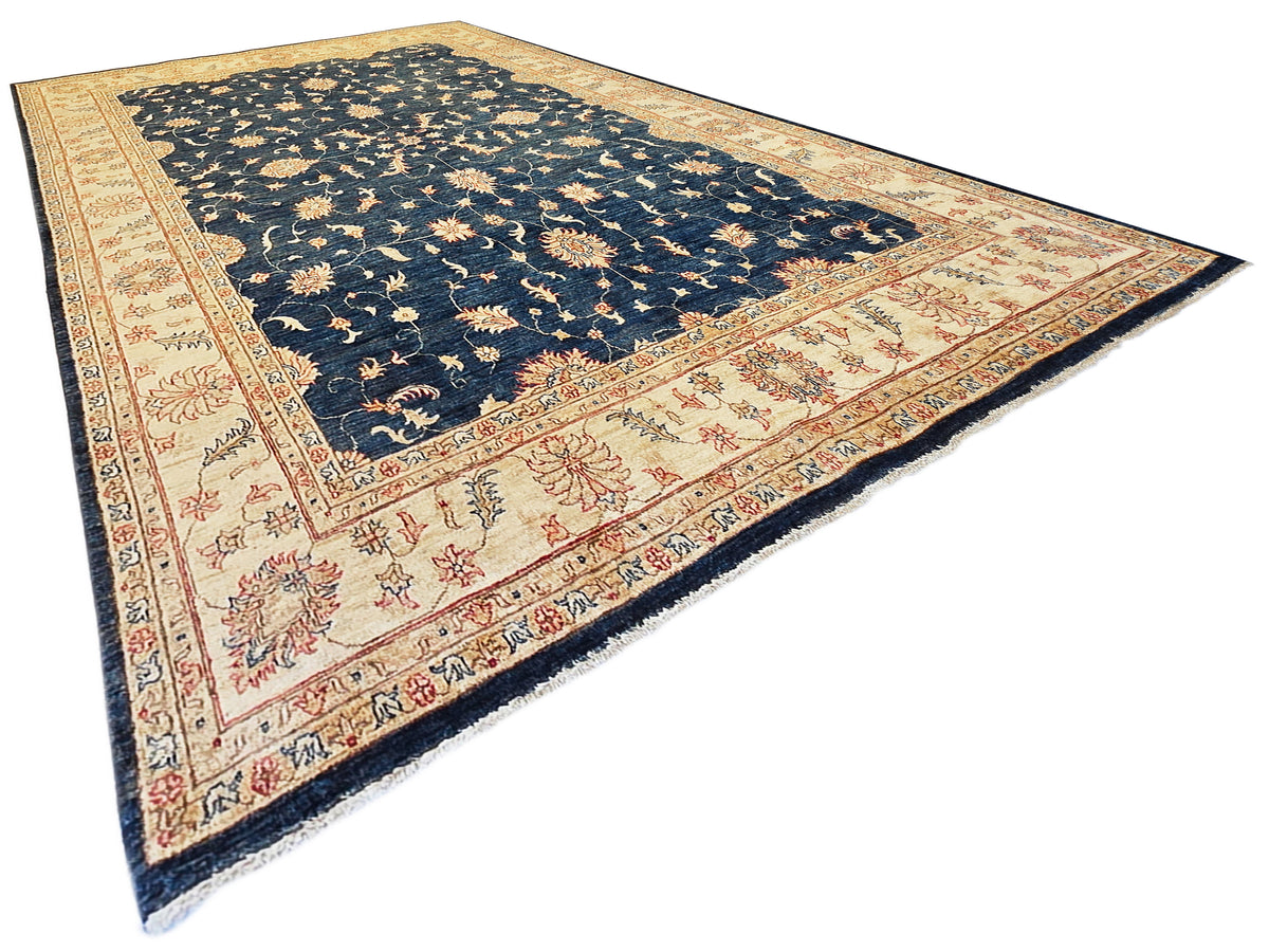 Rectangular navy and cream patterned rug with red floral details and dark fringe edges.