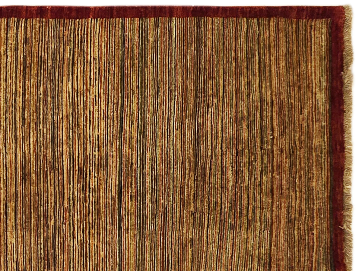 Gabbeh runner rug close-up, fine vertical stripe pattern in brown tones with red edging.