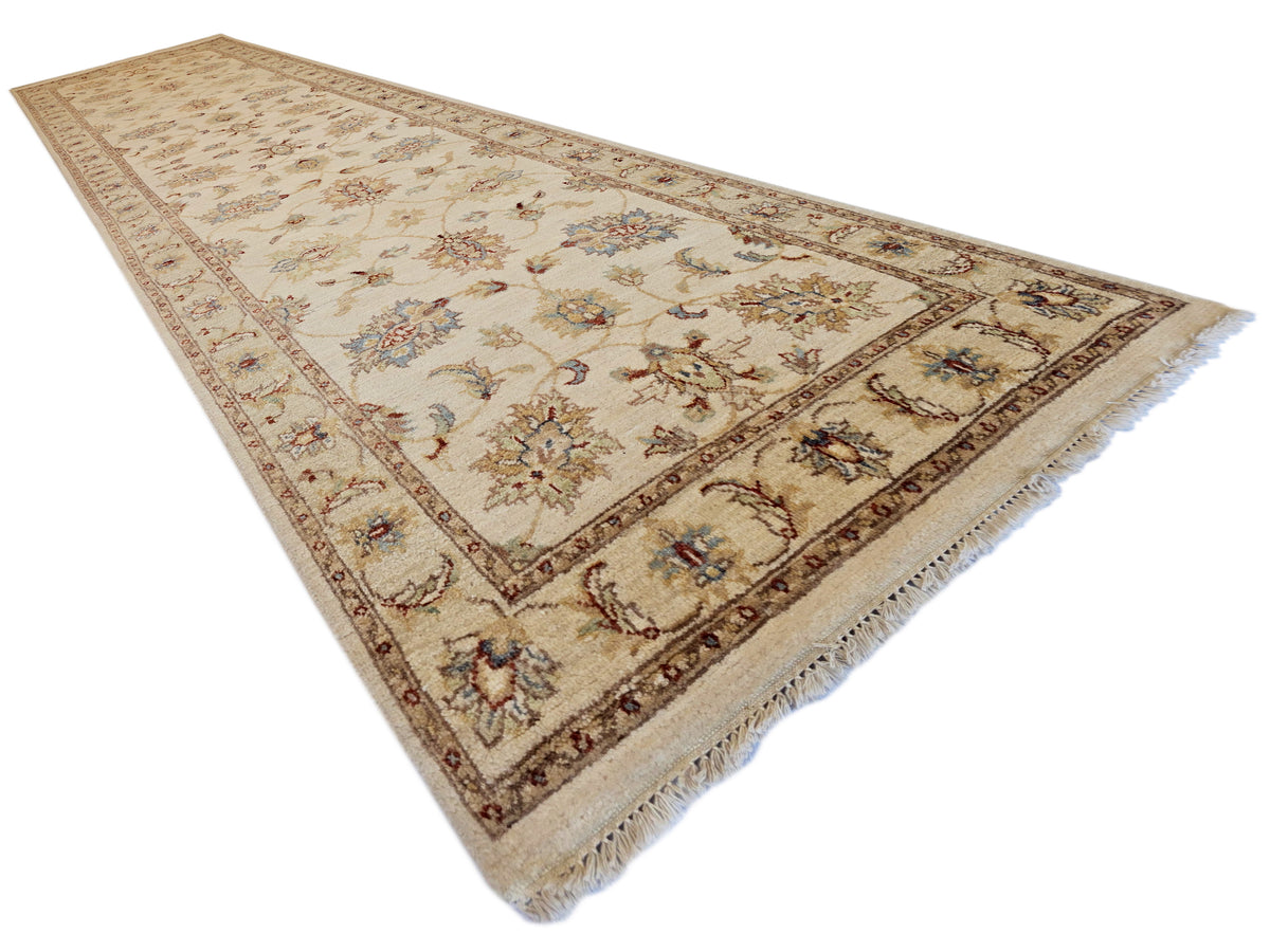 Beige floral runner rug with detailed vine motifs and fringed edges