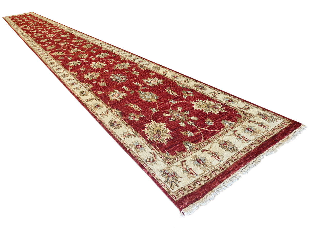 Red runner rug with cream geometric border, floral motifs, and fringed edges, 489x80 cm