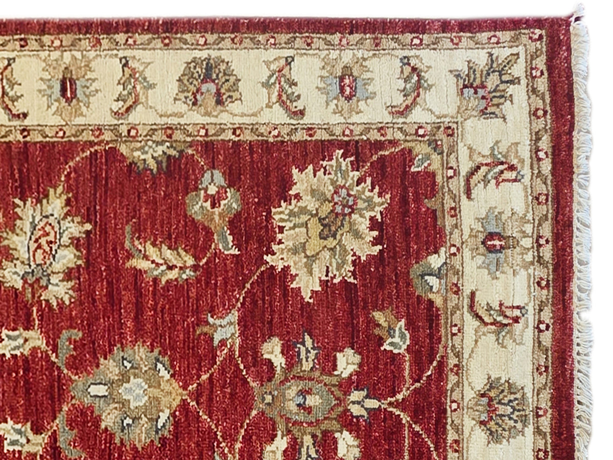 Red and cream rug close-up with floral pattern and decorative border, 489x80 cm