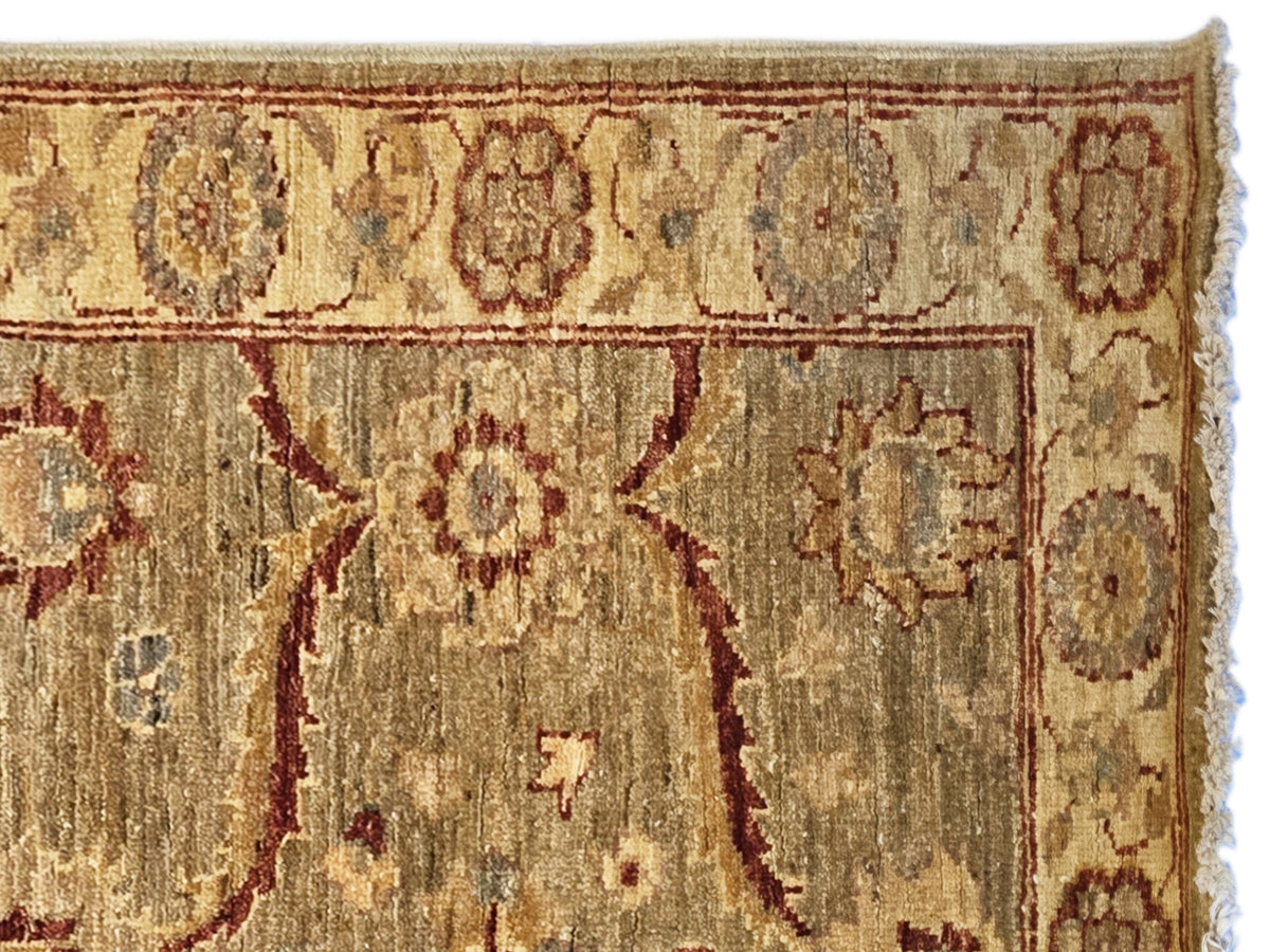 Vintage runner rug close-up, textured beige ground with rust medallion and floral motifs