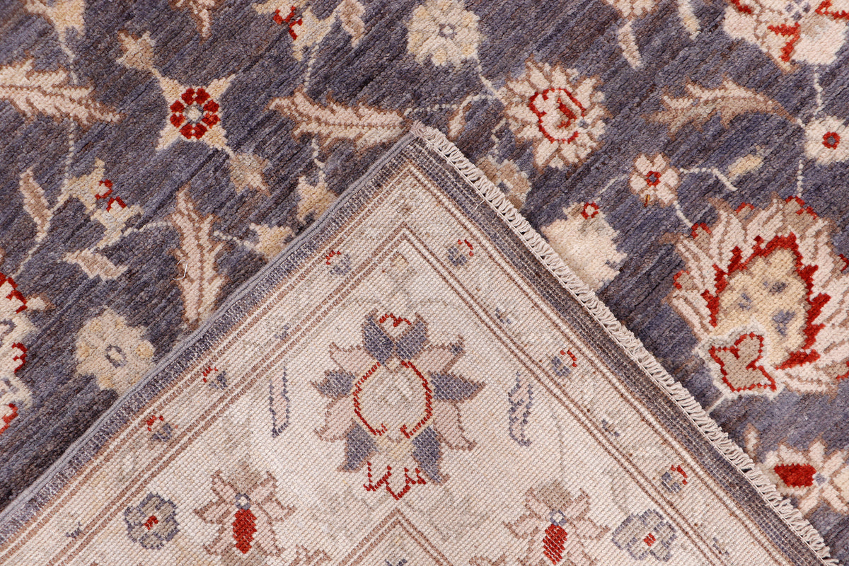 Rug corner detail with beige center medallion, dark blue field, red accents
