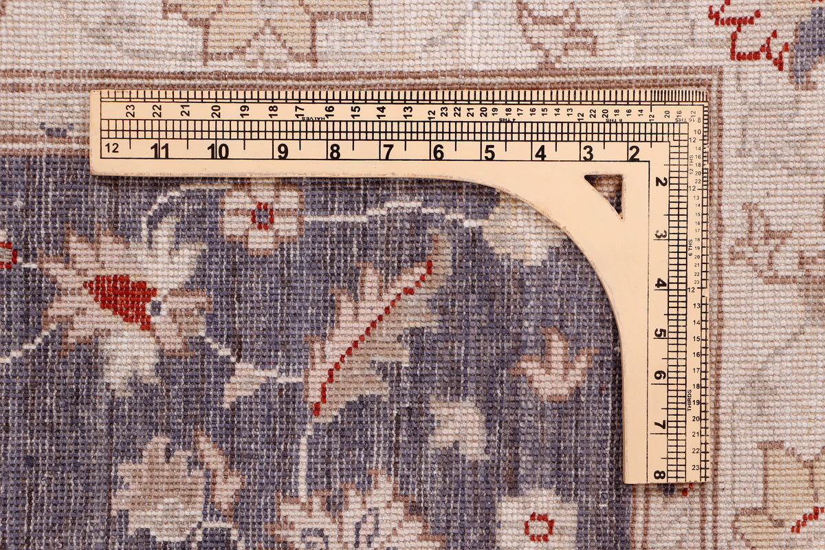 Measuring tape on blue rug pattern with medallion details and red accents