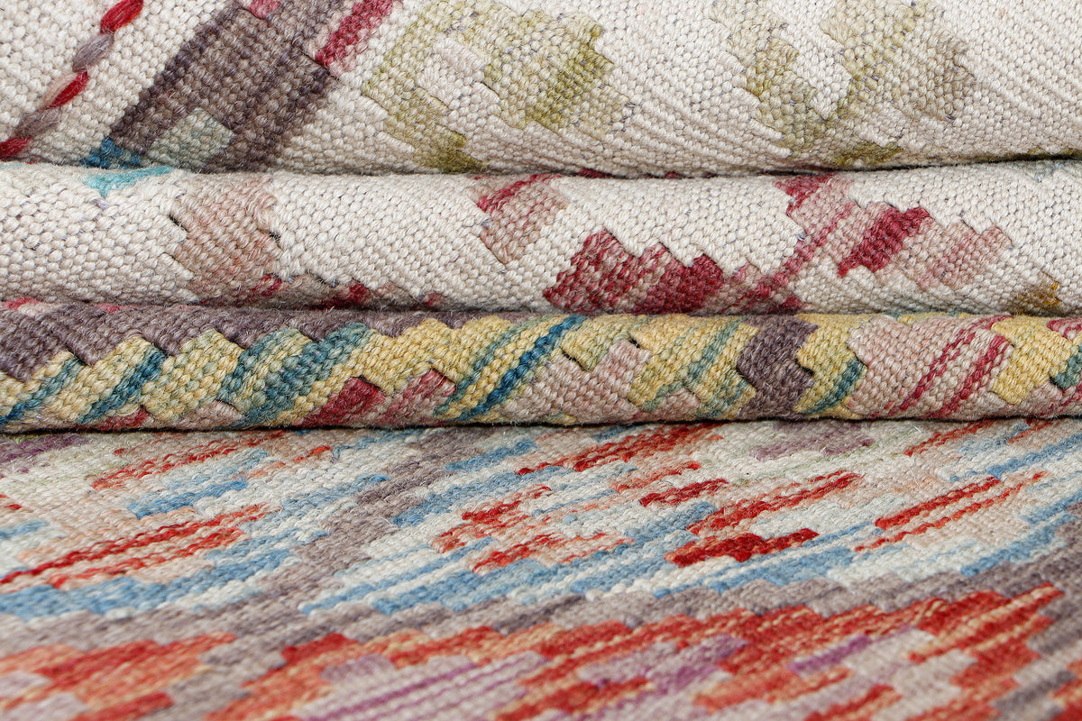 Beige kilim rug edge close-up with stitched border and woven texture