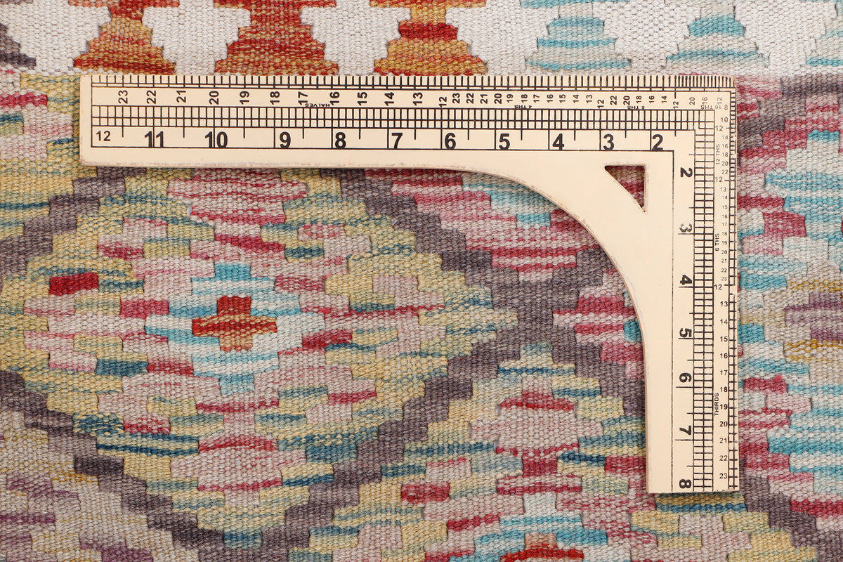 Beige kilim diamond rug close-up of multicolor weave with measuring ruler